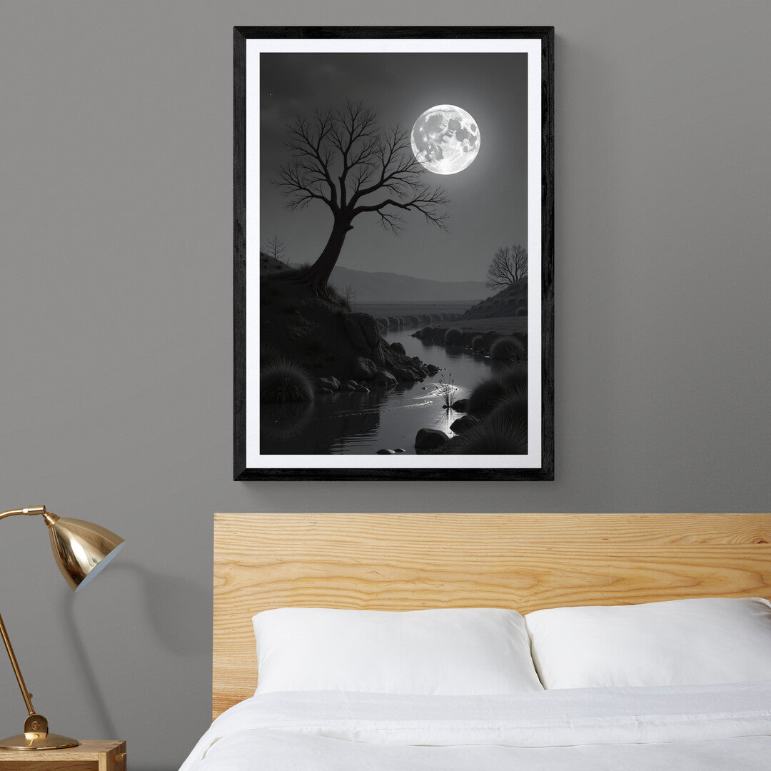 In this serene, monochromatic scene, the night is bathed in the cool, silvery light of a full moon hanging luminously in the sky. The moon, bright and full, dominates the heavens, casting an otherworldly glow over the landscape below. Its light reflects on the surface of a calm river, creating soft ripples that shimmer like liquid silver, highlighting the stillness of the moment.